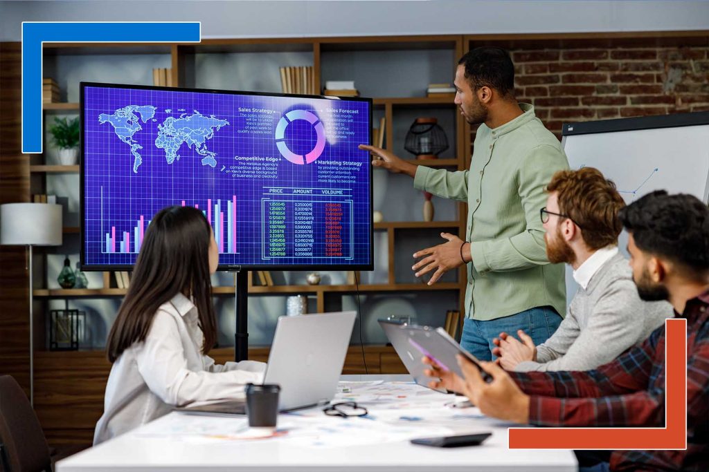 Team reviewing real-time map analytics and global data visualizations on a digital dashboard during a business strategy session.