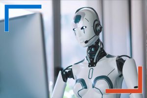 AI robot with headset working at a computer in an office, symbolizing AI developers who deliver production-ready business value.